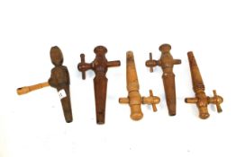 Five antique wooden barrel taps
