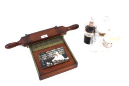 A Victorian brass and mahogany pill making press and a quantity of glass pharmacy bottles.