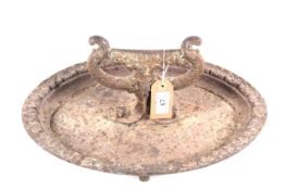 An ornate cast iron boot scraper