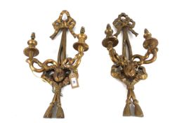 A pair of ornate carved wooden wall sconces