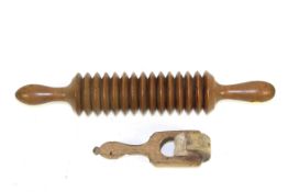 A 19th Century Welsh sycamore crushing roller and a sycamore butter marking wheel with leaves and