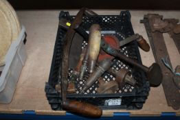 A box containing wood working tools including brace, spoke shave, markers etc.