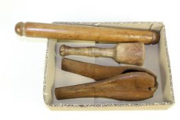 An early 20th Century Treen rolling pin, potato masher and a lemon squeezer