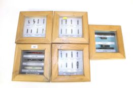 Five display boxes containing various ink pens and nibs