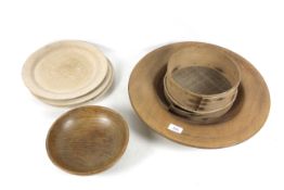 A large wooden bowl, three wooden cutters, an elm dairy bowl and a horsehair sieve