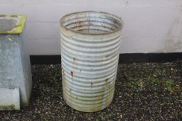 A circular galvanised water butt AF