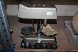 A set of bank scales with nine special weights and some money bags