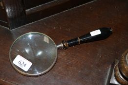 A reproduction magnifying glass (65)