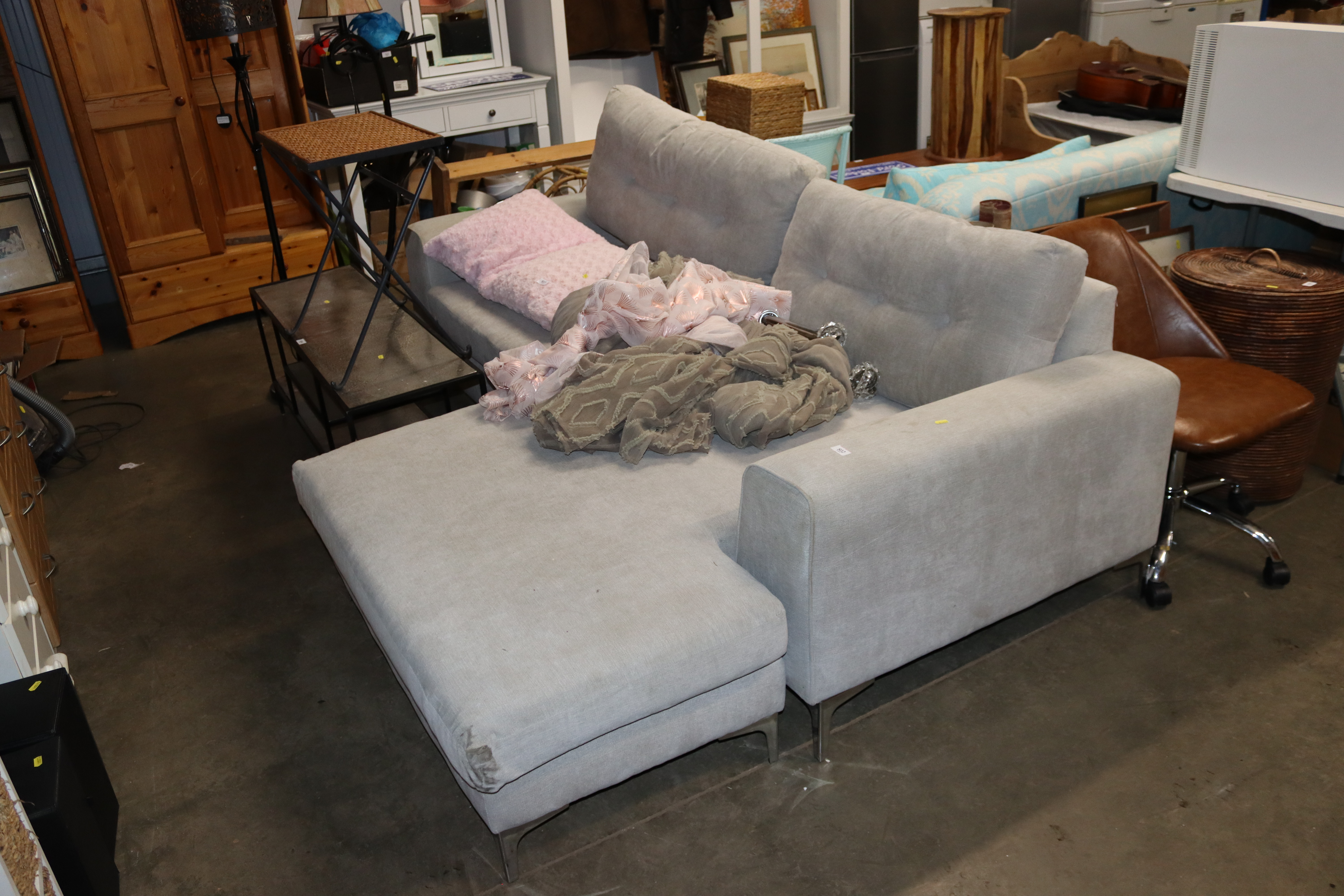 A grey upholstered L-shaped sofa