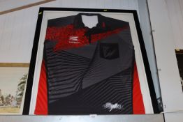 A framed and glazed Phil 'The Power' Taylor dart shirt bearing signatures