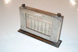 A silver mounted desk calendar by W.J.M. & Co.