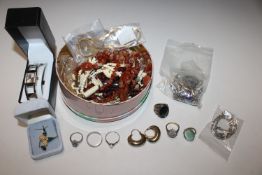 A tin of vintage costume jewellery to include Napi