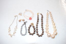 A box containing simulated pearl necklaces and ear