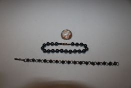 A cameo style brooch in white metal mount marked