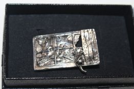 A silver cat and mouse brooch
