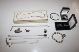 A box containing a silver snap bangle, various oth