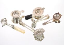A silver tea strainer, Sheffield 1946; a smaller example; a Continental white metal strainer with