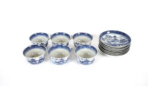 Seven large Chinese porcelain blue and white cups and saucers, and one spare saucer decorated with