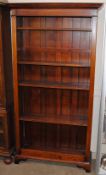 An oak open fronted bookcase, fitted adjustable shelves and raised on a platform plinth, 100cm