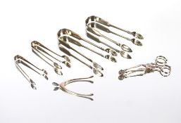 A pair of Victorian Edinburgh silver sugar tongs, with shell shaped terminals; another pair