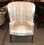 A 19th Century mahogany barrel back armchair, upholstered in floral printed Damask and raised on