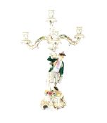 A pair of Dresden five light candelabra, with floral encrusted decoration, the columns with street