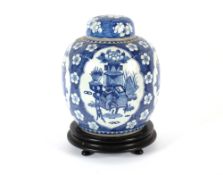 A large Chinese blue and white jar and cover, decorated prunus and objects, 30cm; together with a