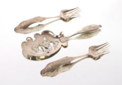 A Continental silver serving slice, with pierced and foliate engraved decoration; and a pair of