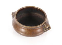 A small late 18th / early 19th Century Chinese circular bronze censor, of squat form with lion