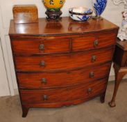 A 19th Century mahogany bow fronted chest, of two short and three long graduated drawers, raised