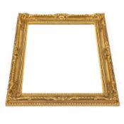A gilt framed bevel edged wall mirror, with shell and foliate scroll pierced decoration, 76cm x 60cm