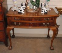 A mahogany bow fronted two drawer cutlery cabinet, raised on cabriole supports and claw and ball