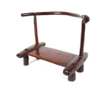 A small African wood stool, on four short legs and curved backrest, fine patination and wear, 28cm