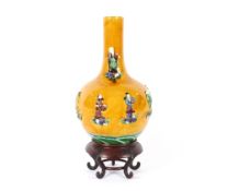 A 19th Century Chinese porcelain bottle vase, the mustard ground body with eight applied immortals