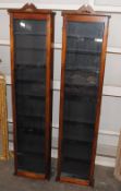 A pair of mahogany wall mounting display cabinets, of shallow proportions, 40cm wide x 173cm high