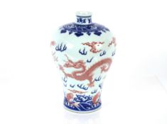 A 20th Century Chinese porcelain Mei Ping shaped vase, painted in underglaze blue and copper, with