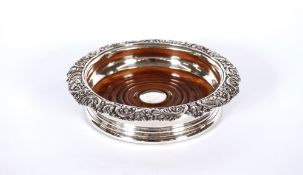 A heavy George III silver bottle coaster, by Rebecca Emes and Edward Barnard, having turned wooden