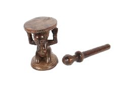 A small African wooden stool, 18cm high, the seat supported by a kneeling female figure and a double