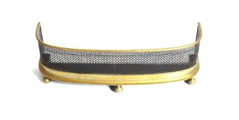 A Victorian brass and wire work D shaped fender, raised on ball feet, 88cm wide
