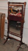 A 19th Century mahogany cheval mirror, in turned stand raised on reeded supports, terminating in