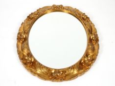 A large oval decorative gilt framed wall mirror, in the Rococo style with bevel plate, 84cm x 70cm