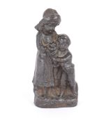 A small Victorian cast iron door stop, in the form of two children holding a dog, 16cm high