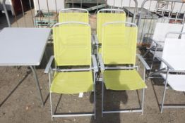 A metal folding table and set of four metal foldin