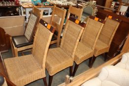 A set of four oak and wicker dining chairs