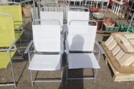 A set of four metal folding chairs