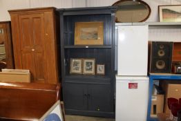 A painted pine bookcase raised on cupboard base fi