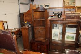 An oak corner cabinet together with a reproduction