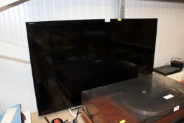 A Sony flatscreen television with remote control,