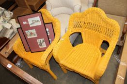 A pair of yellow painted wicker chairs