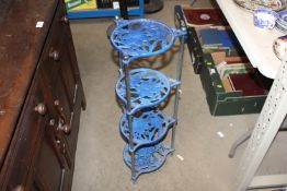 A cast iron four tier pot stand